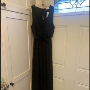 Super cute black jumpsuit with cute bow detail in the waistline and pockets